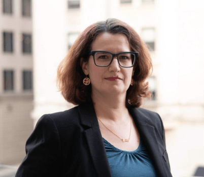 Photo of Nathalie Maréchal standing in front of a cityscape